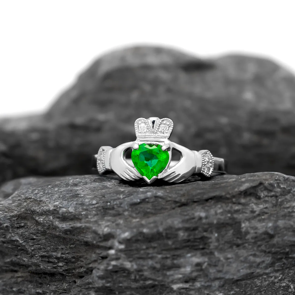 Elegantly Designed Claddagh Ring Featuring A Glistening Heart-shaped Emerald